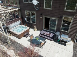 Main level patio with hot tub, a bistro table and a gas BBQ