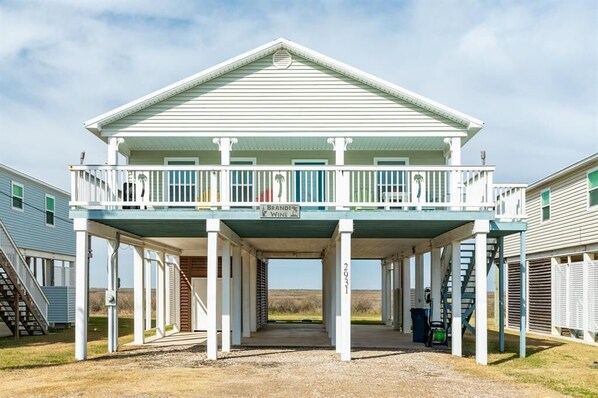 Blue Paradise is a newer coastal contemporary open concept home with views of beach and bay and offers comfortable living spaces with easy beach access.