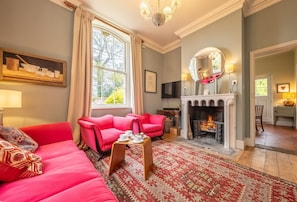 The Gate House, Wolterton Park, Blickling: Sitting room with bright, comfortable seating and an open fire
