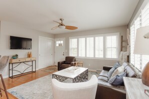 Upstairs living area with TV and seating