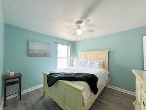 Unwind and let go in our tranquil bedroom, featuring a queen-sized bed dressed in luxurious linens and topped with soft, supportive pillows. It's the perfect sanctuary for a restful night's sleep and a rejuvenating start to your day