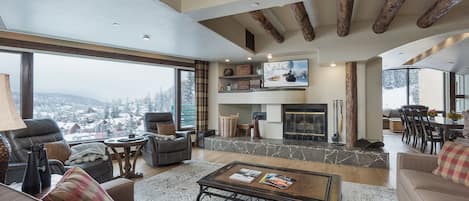 Main Living Space - TV, Wood burning fireplace and awesome picture window of the slopes