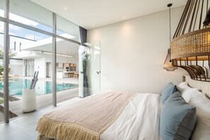 Cozy Bedroom with a Pool View