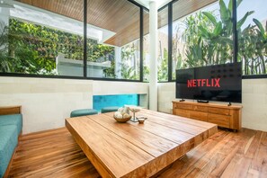Cozy LIving Room with 65 inch smart TV for entertainment