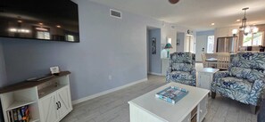 Open-Concept Living & Dining – Bright, Beachy Comfort at Dan’s Florida Condos all with a lovely smart TV and bay views!