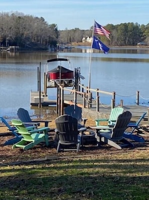 Fire pit with 8 chairs and view of lake