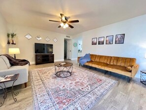 Main Living room, flat screen TV, open to dining area! comfy throw blankets!
