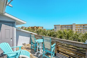 Private balcony with ocean views and cozy seating to soak in the sea breeze.