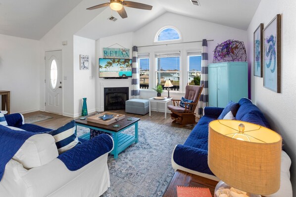Relax in the spacious Living Area with a flat-screen TV, plenty of cozy furniture, and beautiful nautical decor.