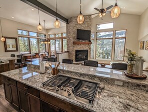 The kitchen, wet bar, living and dining areas are part of a wide-open floor plan