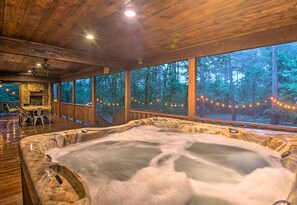 Unwind in the luxurious hot tub with a forest view—perfect for soothing relaxation in any season