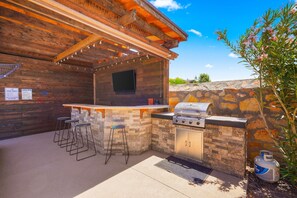 Back yard tiki bar with 55" smart TV and propane grill