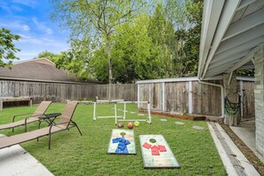 Huge backyard with soccer set, cornhole set, and football. Basketball and basketball hoop included.