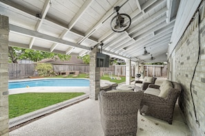 Grill, outdoor seating, and pool chaise lounge