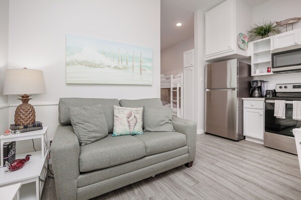 Comfortable living area with twin size sleeper sofa and flat screen TV