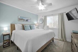 Coastal calm meets king-sized comfort—your relaxing retreat after beach days.