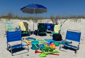 Beach chairs, towels, umbrella, cooler, and toys—plus the wagon to haul it all.
