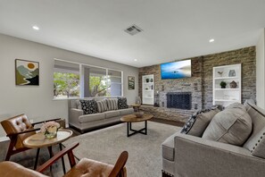 Spacious living room around the fireplace.