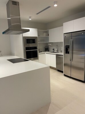 Full kitchen - fridge, stove, oven, microwave, dishwasher, dishes, and utensils