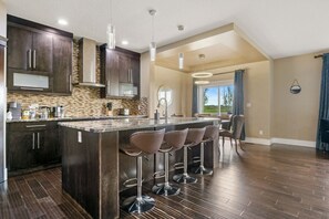 Fully-equipped kitchen, boasting a ice maker, modern appliances, and a coffee machine for your morning brew.