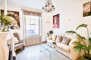 Comfortable family living area featuring high ceilings and  French chandeliers