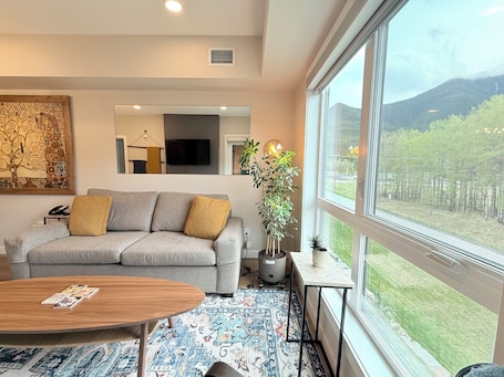 Living Room w Sofa Bed, Smart TV, Electric Fireplace and Beautiful Window View.