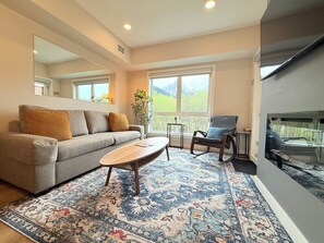 Living Room w Sofa Bed, Smart TV, Electric Fireplace and Beautiful Window View.