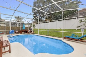 Poolside paradise: Relax in our enclosed back patio oasis, complete with outdoor dining tables for al fresco dining.