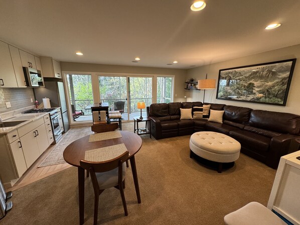 Living and dining area with wooded view