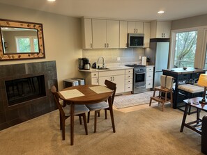 Full kitchen with adjacent dining area and fireplace