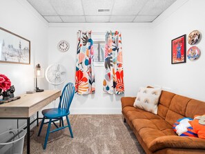 Cozy up in this serene living room oasis with a comfortable couch and a stylish desk. The perfect space to relax and let your creativity flow. 🌿 #HomeSweetHome