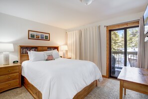 Cozy queen second bedroom with balcony access—your peaceful retreat awaits!