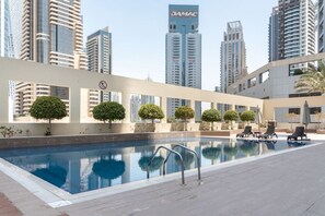 Rooftop Pool Oasis: Dive into luxury with stunning city views and relaxing sun loungers!