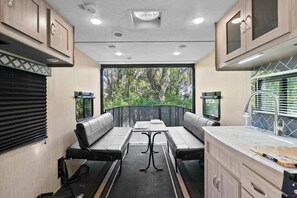 The living room is a cozy space with comfortable chairs and the perfect table to enjoy.