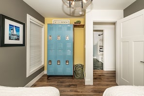 Two Twin XL beds. Locker storage and room to hang clothes too. Ceiling fan.
