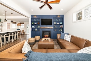 Open plan, cozy electric fireplace, lots of seating, open to gourmet kitchen.