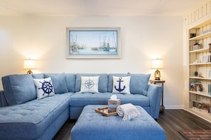 Lounge on our comfy couch and relax after a day exploring OBX.