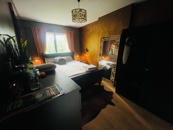 Bedroom with super comfy king bed, new wardrobe, drawers, curtains, mirror, rugs