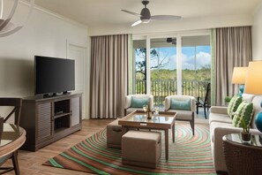 Separate living room with a sleeper sofa and a furnished balcony.