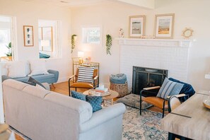 Inside, discover a cozy retreat adorned with rustic furnishings and tasteful decor. Sink into plush sofas in the living area, warmed by the crackling fireplace on cooler evenings.