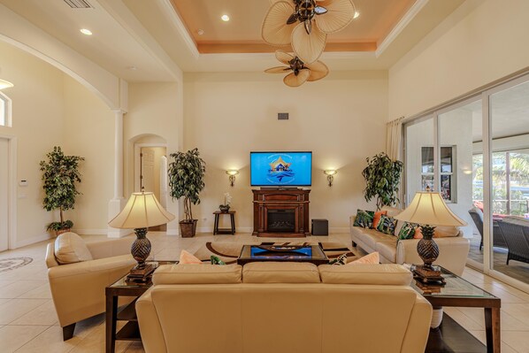 Cozy Entertainment Hub - - Unwind in this warm and inviting living room, perfect for family movie nights
- Soft lighting and elegant furnishings create a peaceful yet comfortable space
- The ideal gathering spot to relax and make cherished memories together