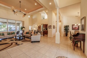 Grand Living - - Step into this elegant, high ceilinged living room filled with natural light
- Comfortable seating and vibrant decor create a warm, welcoming atmosphere
- A sophisticated space that’s perfect for entertaining or cozy family time