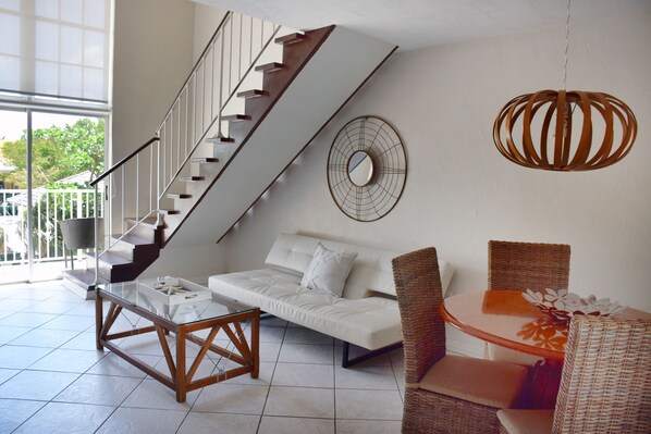 Nicely appointed living room with seating and dining areas