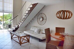 Nicely appointed living room with seating and dining areas