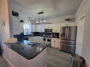 Kitchen has everything needed for cooking and dinging