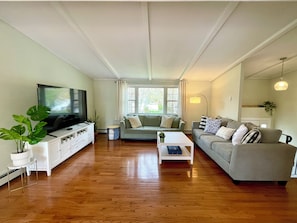 Large living room with 75" HD Smart TV.