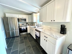 Fully equipped kitchen with stainless steel appliances.