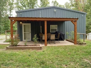 Covered area with table for 6 and gas grill for outdoor family gatherings. 
