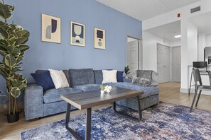 Unwind in the spacious living area complete with a comfy couch to relax after a long day exploring the city!