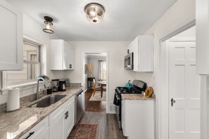 Step into this modern kitchen oasis with sleek white cabinets and glistening stainless steel appliances that effortlessly blend style and functionality.✨